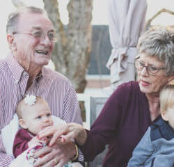 An Old Couple Holding Their Grandchildren, Baby Boy and a Baby Girl "Estate Planning Attorney"