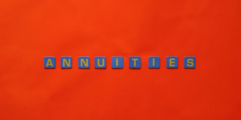 A Close-up Shot Of Text That Saids "Annuities" On A Red Surface. My Annuity And Estate Planning