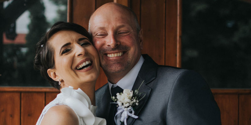 A newlywed couple smiling - Newlywed Planning: Why Joint Tenancy May Not Be the Best Option. Corona Estate Planning Attorney.