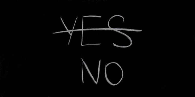 A Blackboard With a No and Yes Word, Yes Is Marked With a Line Across It as an Answer for Medicaid Application Denied